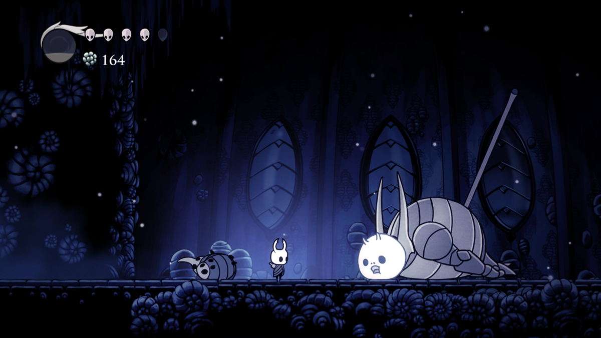 Hollow Knight screenshot. Shows the player fighting a giant knight with an exposed squishy head.